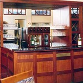 Bar, built-in: glass, granite, mirror, stained mahogany and natural anigre.