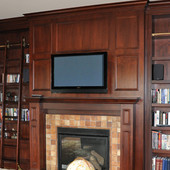 Paneled Library with fireplace surround and rolling ladder, built-in: stained gl
