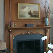 Fireplace Surround, built-in: stained and glazed cherry with carved accents.