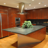 Boat shaped kitchen island designed by Ginger Woods LLC. Ribbon-striped mahogany and brushed aluminum. 