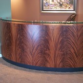 Reception desk:  "Barked" glass with stainless steel pylons, stained crotch maho