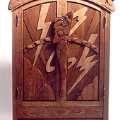 Armoire, freestanding: natural cherry and maple with hand carved relief.