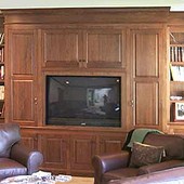 Wainscoted Room with Bookcases and TV Cabinet, built-in: stained walnut.